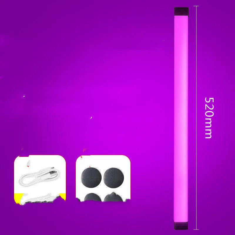 Blue rechargeable LED light tube with USB plug and push-button switch on a dark surface