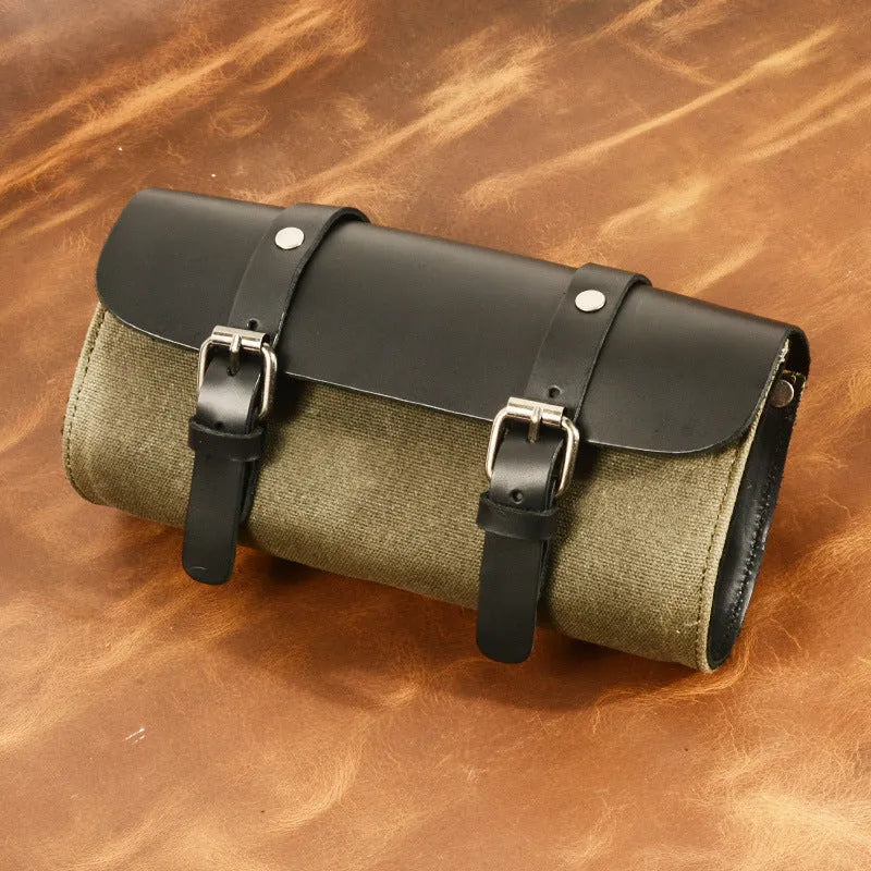 Camel Bag Knight retro cotton messenger bag in army green, showing front flap, rivet details, and size next to a motorcycle helmet.