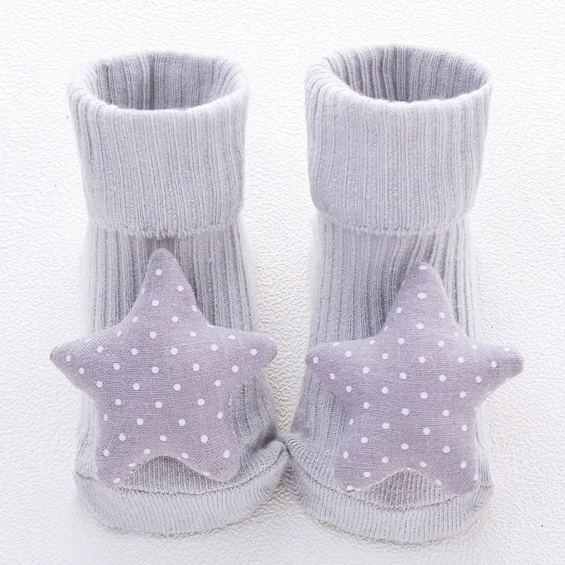 Cotton baby floor socks in assorted colours and patterns including bows, stars, and animal designs.