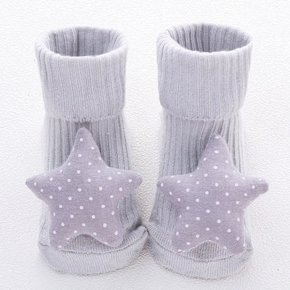 Cotton baby floor socks in assorted colours and patterns including bows, stars, and animal designs.
