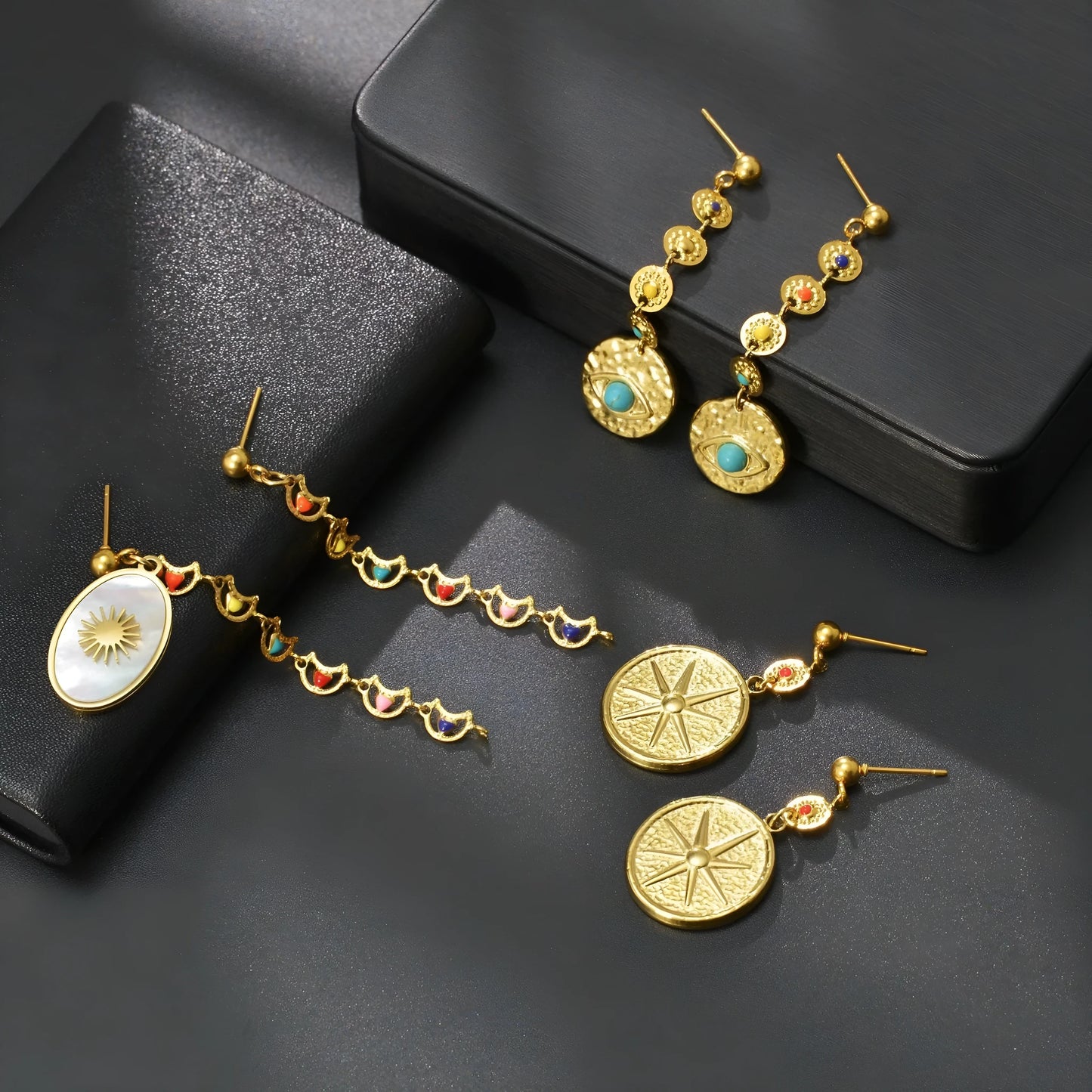 Stainless steel geometric earrings in three design options: Eight Awn Star, Eye, and Shell Sun styles