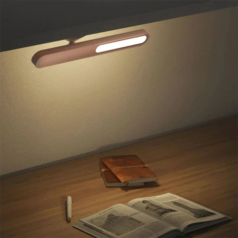 A modern, geometric desk lamp with wireless charging and a magnetic suction base for easy placement