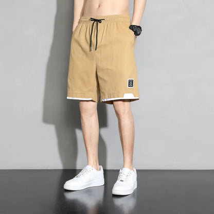 Cotton shorts for teenage boys in black, shown on a hanger, featuring a mid-waist design.