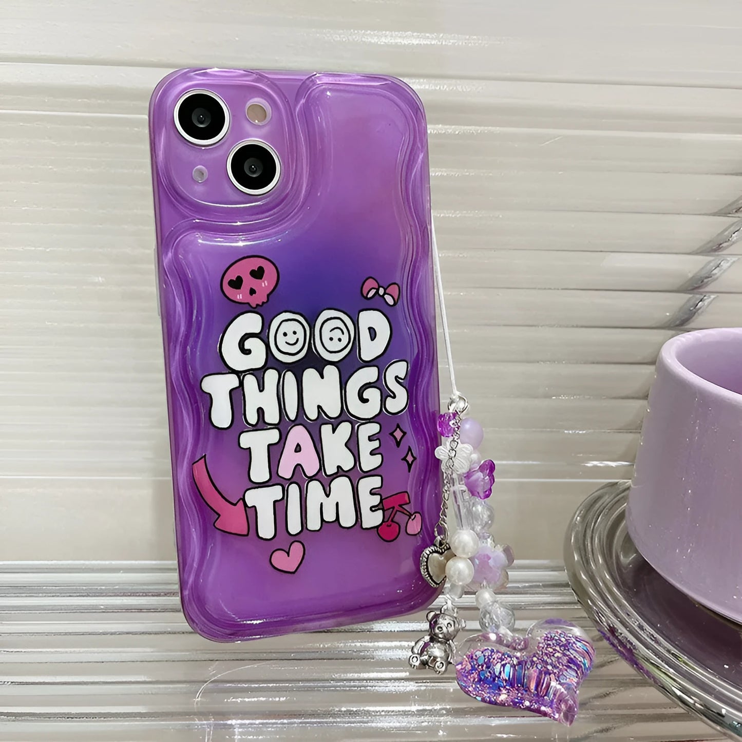 Purple graffiti design iPhone case with a silver love pendant chain attached