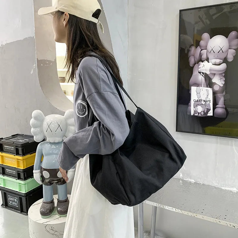 Solid colour women's canvas handbag with double shoulder straps showing internal mobile phone compartment