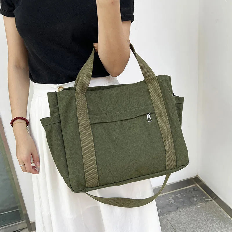 Army Green canvas tote bag showing open top with internal laptop pocket and organisers.