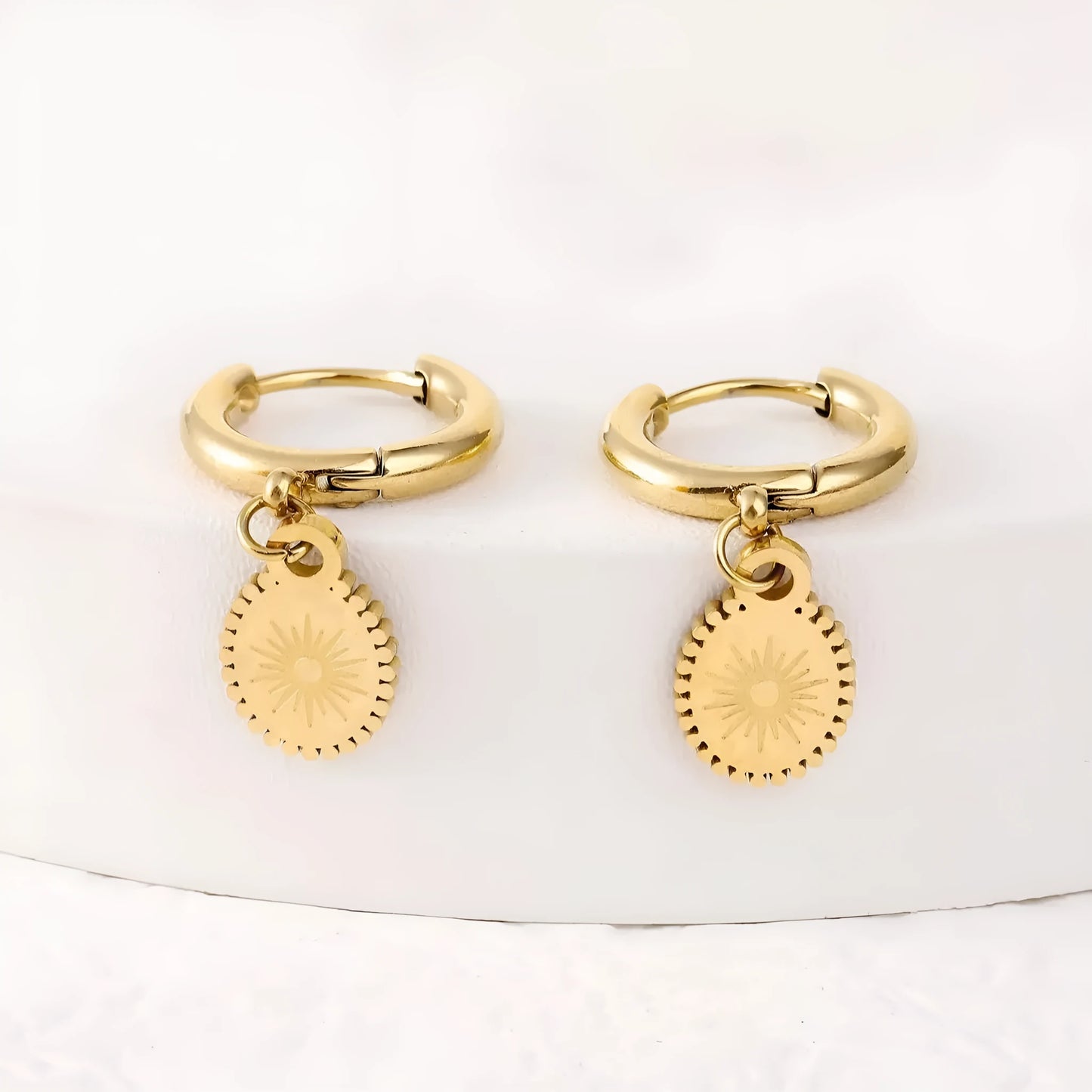 Geometric stainless steel earrings with ellipse design and ear button fastening, approximately 2-3cm diameter
