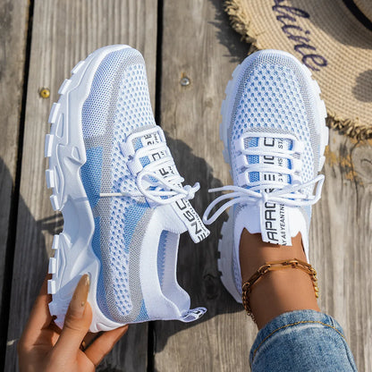 Women's Flyknit mesh lace-up sneakers in a grey colourway on a white background