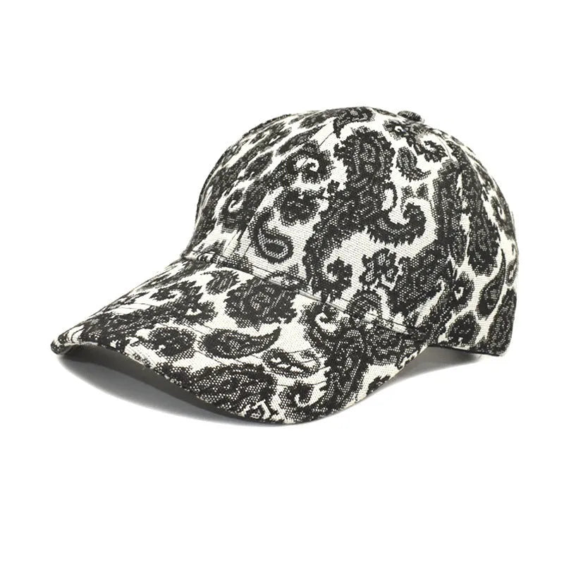 Blue polyester baseball cap with white paisley pattern print, showing dome crown style.
