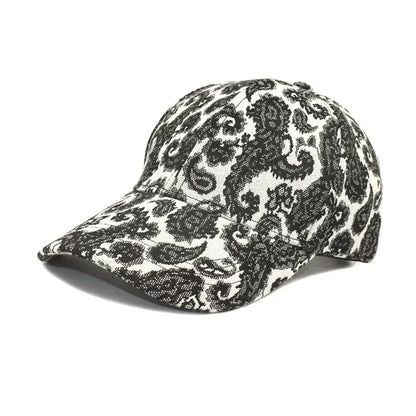 Blue polyester baseball cap with white paisley pattern print, showing dome crown style.