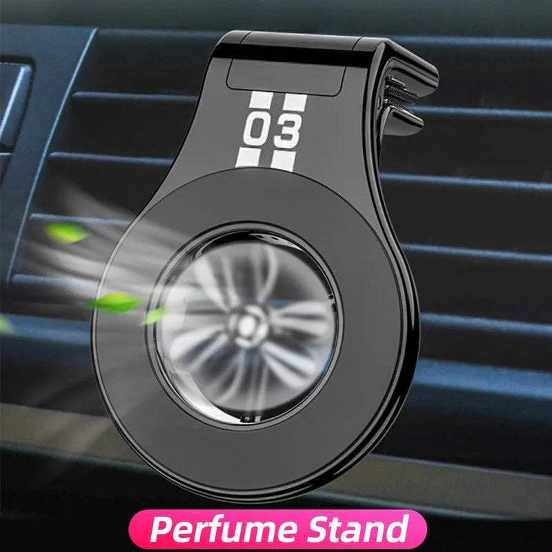 Black magnetic car phone holder attached to air vent with smartphone mounted and fragrance slices visible
