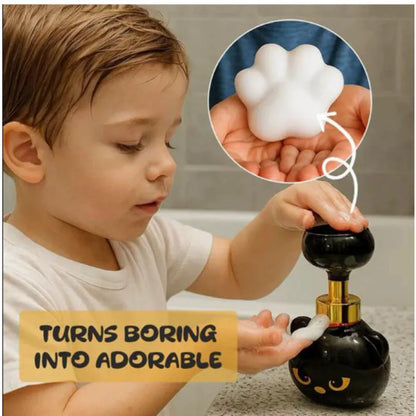 Black plastic cartoon cat-shaped manual soap dispenser on a countertop.