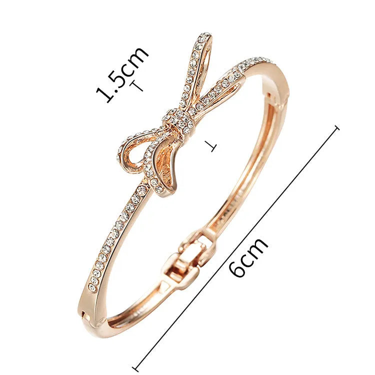 Women's rose gold alloy bracelet with bow design, diamond accent, and electroplated copper finish