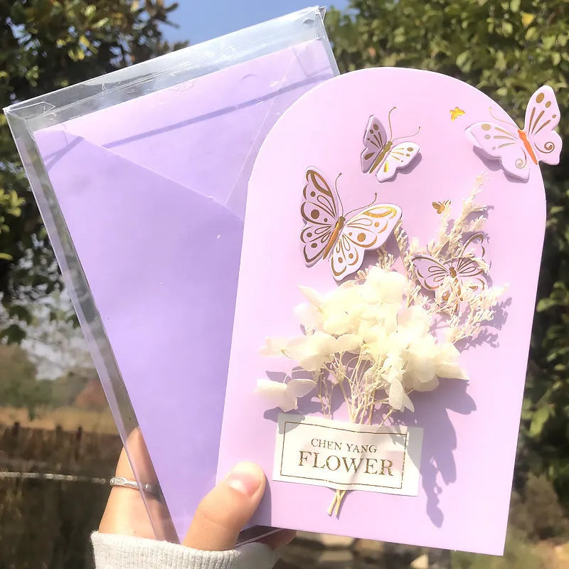 Handmade 3D pop-up greeting card with butterfly shape showing artificial flowers and hot stamping details
