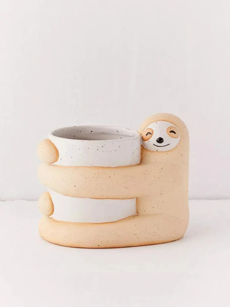 Ceramic sloth flower pot with drainage holes measuring 13.5cm height