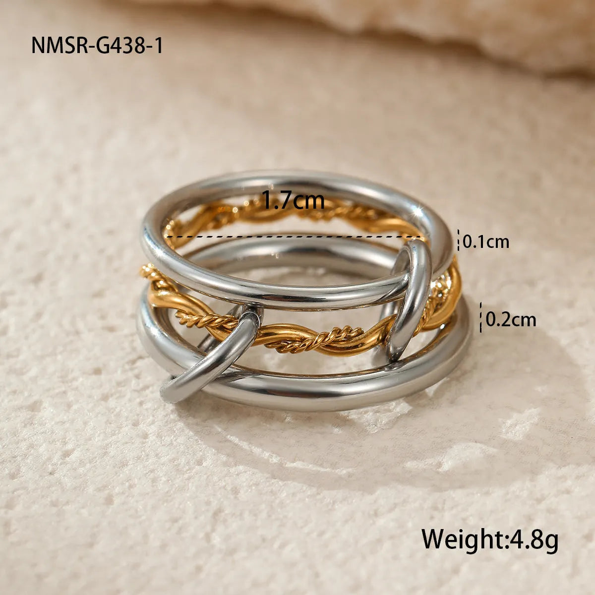 Stacked stainless steel rings with 18K gold plating in three colour variations, exaggerated hand jewellery designs