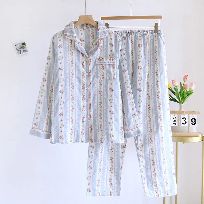 Red fruit print cotton gauze ladies' pyjama set with long sleeves and trousers laid flat.