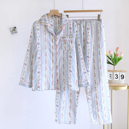 Red fruit print cotton gauze ladies' pyjama set with long sleeves and trousers laid flat.