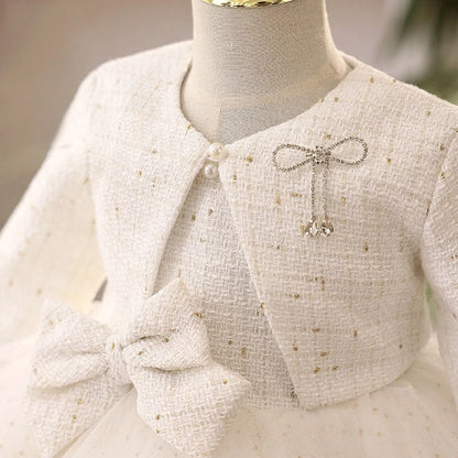 White long-sleeved flower girl wedding dress with princess styling on mannequin