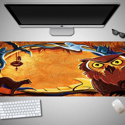 Oversized black Halloween-themed mouse pad with graphic design on a wooden desk, showing non-slip rubber base.