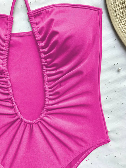 Women's solid color one-piece swimsuit with adjustable strap in brown, black, and rose red