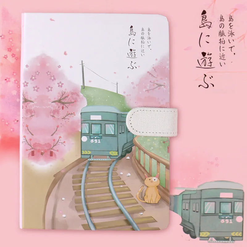 A5 wire-bound retro notebook open showing full-colour illustration of a train on its page