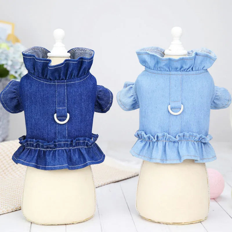 Blue denim dog dress with ruffles and integrated harness for leash attachment.