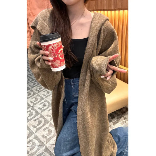 Women's Korean style hooded long knitted cardigan in oatmeal colour, showing loose fit and below-the-knee length