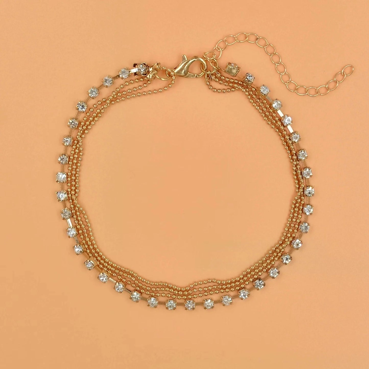 Women's geometric bead anklet with adjustable chain in gold and silver options.