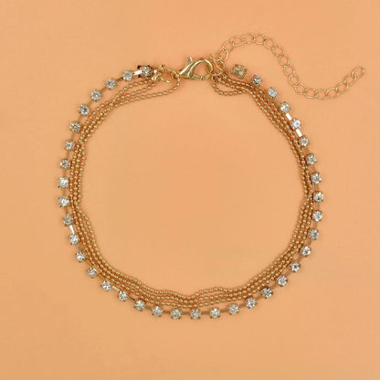 Women's geometric bead anklet with adjustable chain in gold and silver options.