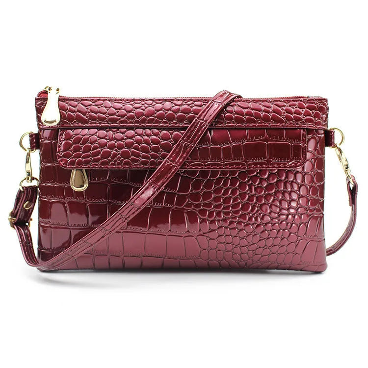 Women's black PU messenger bag showing horizontal square shape and shoulder strap
