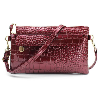 Women's black PU messenger bag showing horizontal square shape and shoulder strap