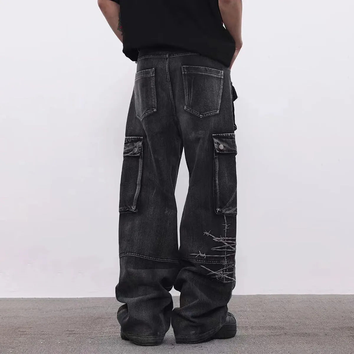 Men's black wide-leg cotton trousers with embroidery details on mid waist design