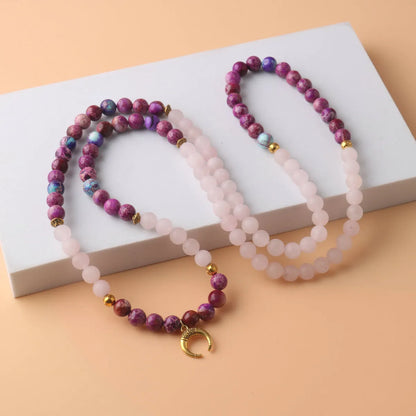 Round pink crystal emperor stone bead pendant on a women's personalised necklace.