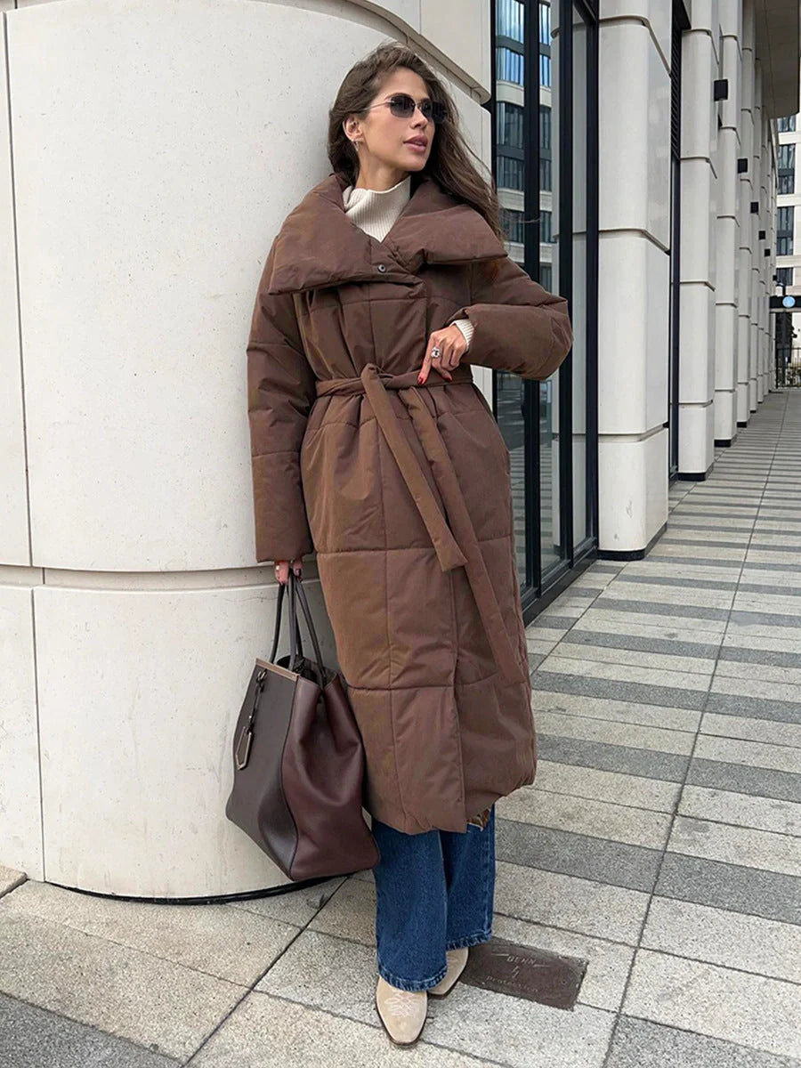 Cozy women's long winter coat with large lapel, lace-up design, and pockets for optimal warmth and style