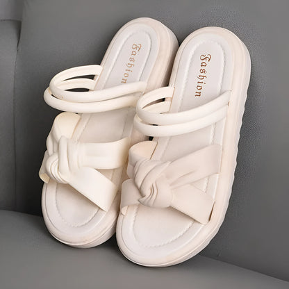 Women's black PVC sandals with thick soft back, floral detail, and injection moulded sole