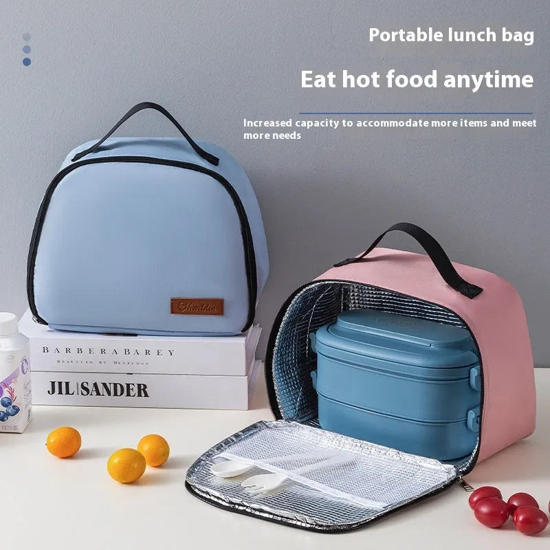 Insulated lunch box bag in sapphire blue textured cloth, shown with a lunch box inside.
