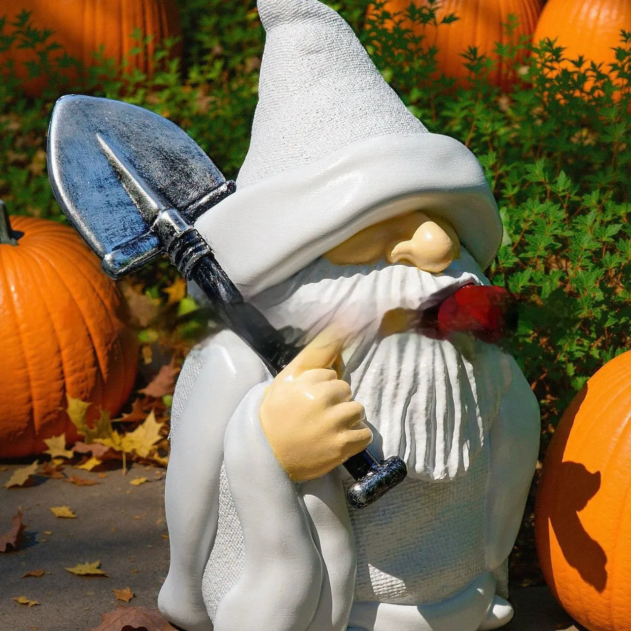 Resin Christmas garden ornament showing dwarf holding smoking shovel, 8cm height