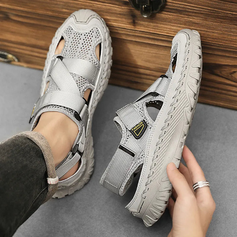 Men's grey casual sandals with hollow mesh upper, elastic band, and rubber sole.