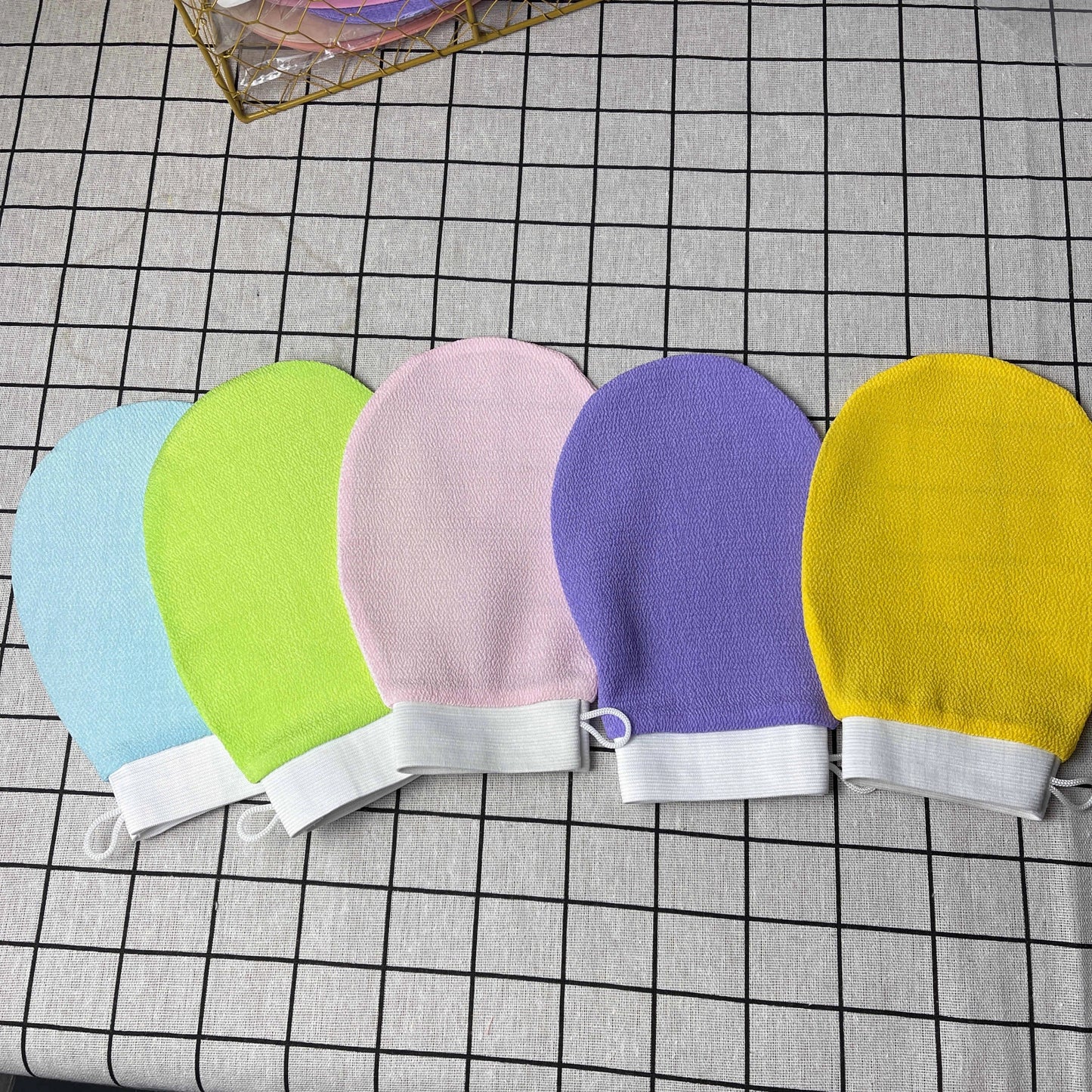 Luxurious exfoliating bath gloves in various vibrant colors, made from soft viscose fiber for a spa-like cleansing experience