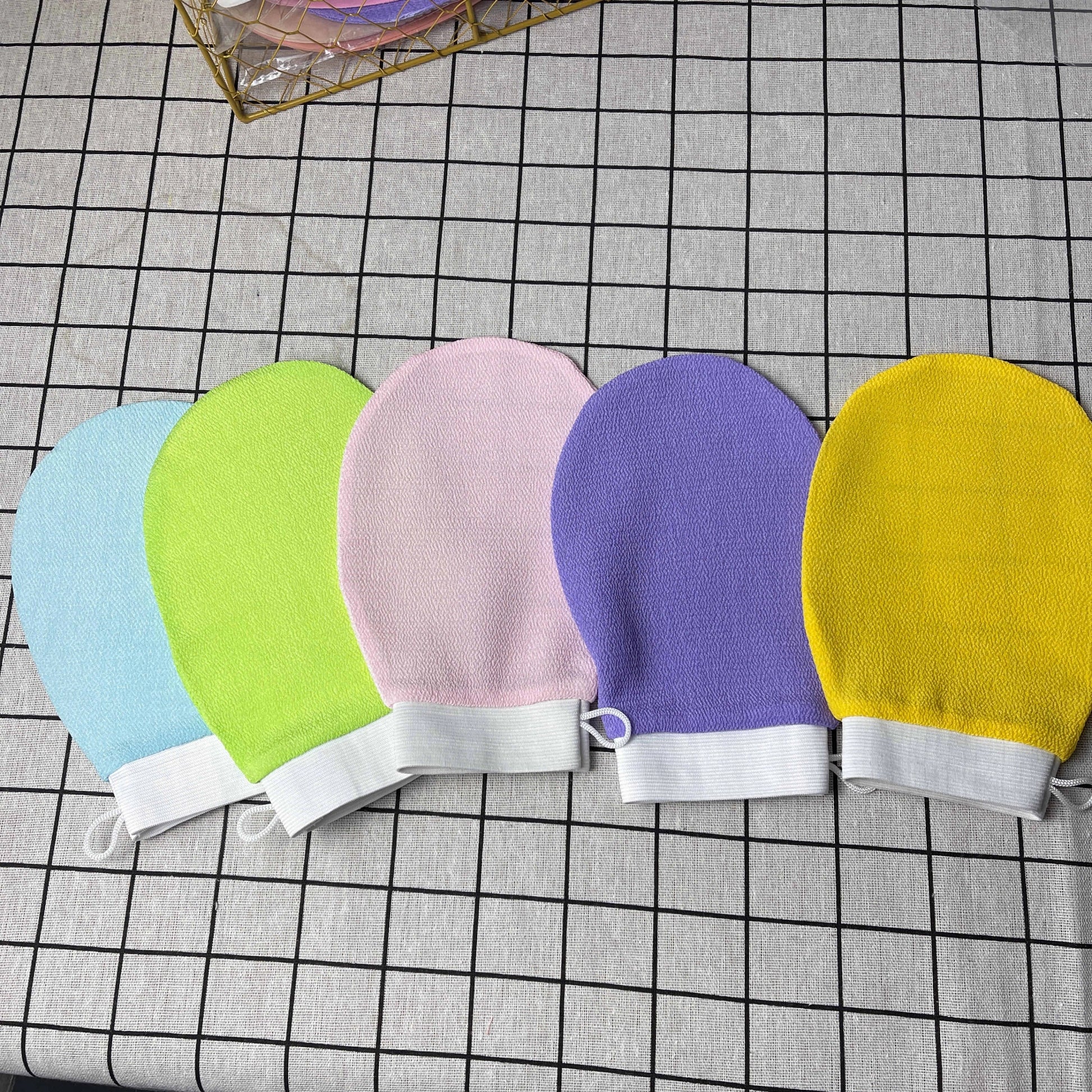 Luxurious exfoliating bath gloves in various vibrant colors, made from soft viscose fiber for a spa-like cleansing experience