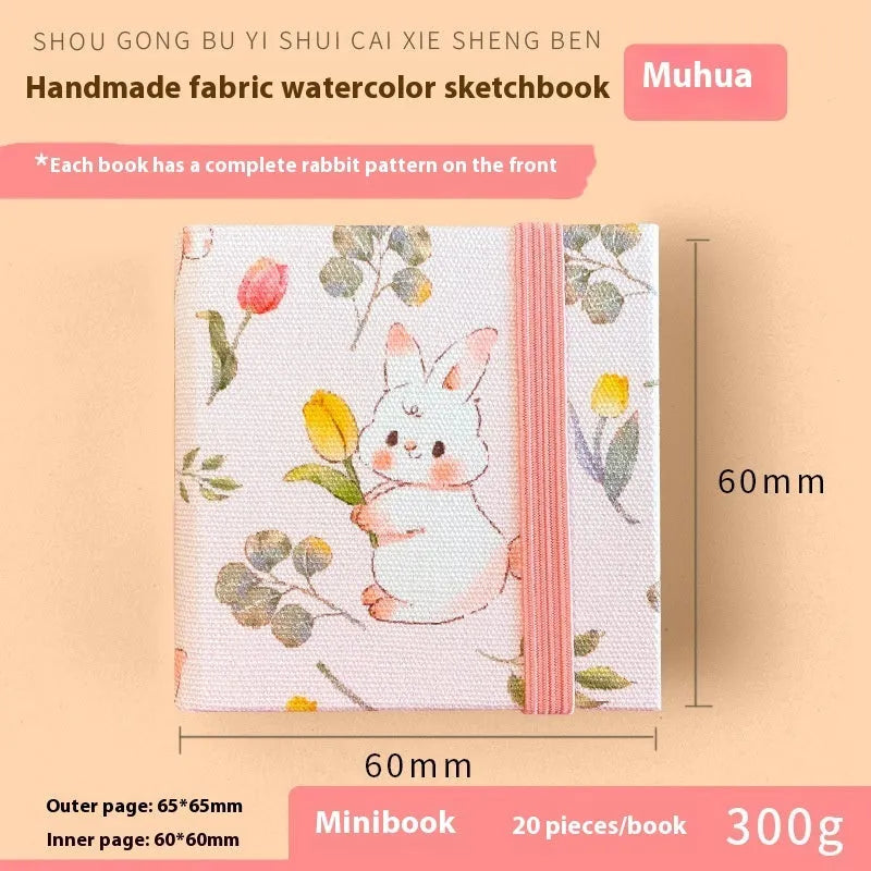 Feiluniao watercolour notebook with fabric cover, 185mm length, open to show paper for painting.