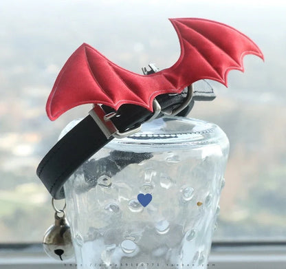 Black patent leather choker with 15cm wings decoration and bell attachment on adjustable 30-40cm collar