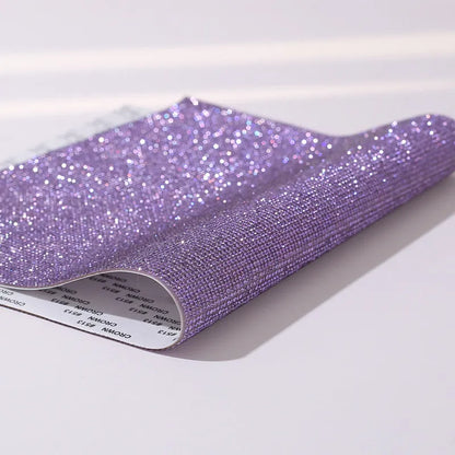 Rhinestone sticker net on backing sheet for hot drilling application to fabrics in multiple colour options