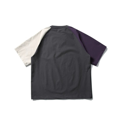 Dark grey loose fit men's t-shirt with contrast colour raglan sleeves on a hanger.
