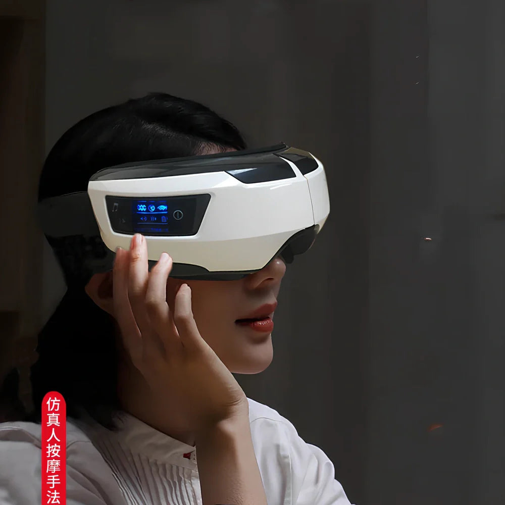 Black and white eye massager with USB cable, showing contoured design for eye socket placement