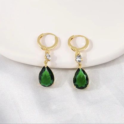 A pair of green geometric teardrop-shaped alloy earrings on a plain background.