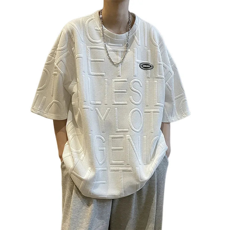 Grey men's loose T-shirt with a raised black three-dimensional retro letter design on the chest.