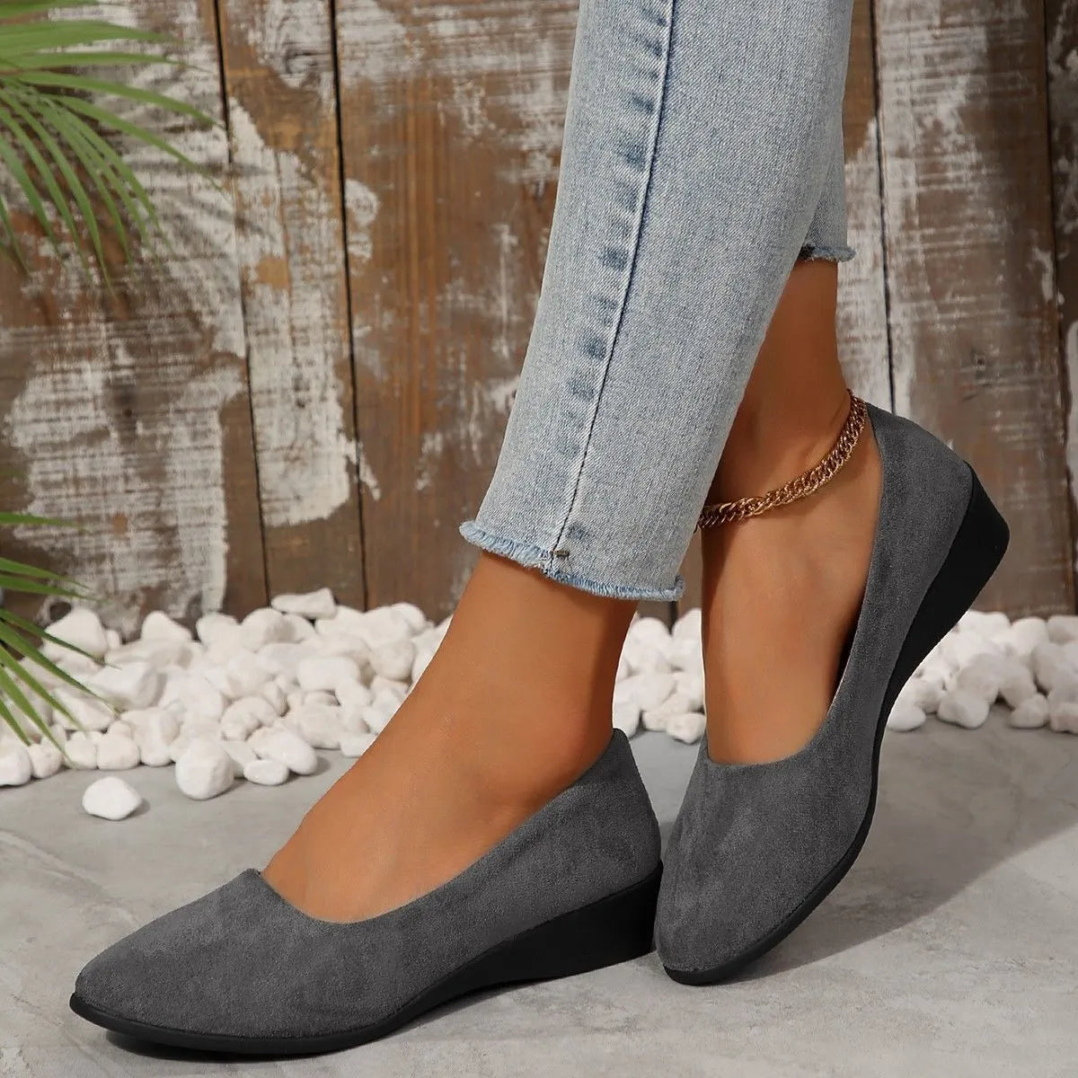 Women's black pointed toe wedge pumps with suede upper and low rubber sole