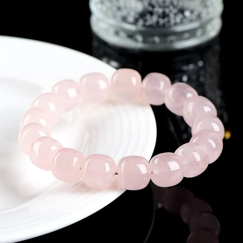 Pink crystal barrel bead bracelet with geometric design measuring 11-12mm beads on wrist
